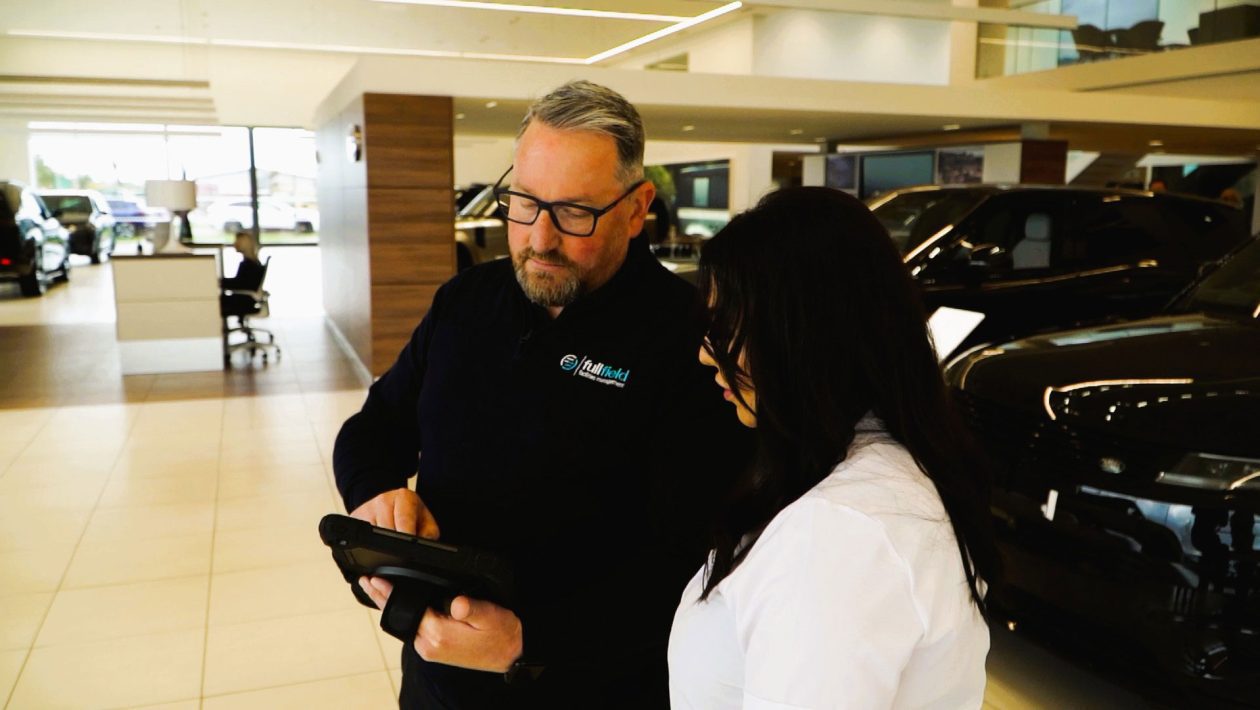 Fullfield employee talking to car dealership staff        