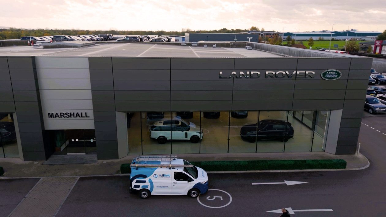 Fullfield van outside Land Rover car showroom        
