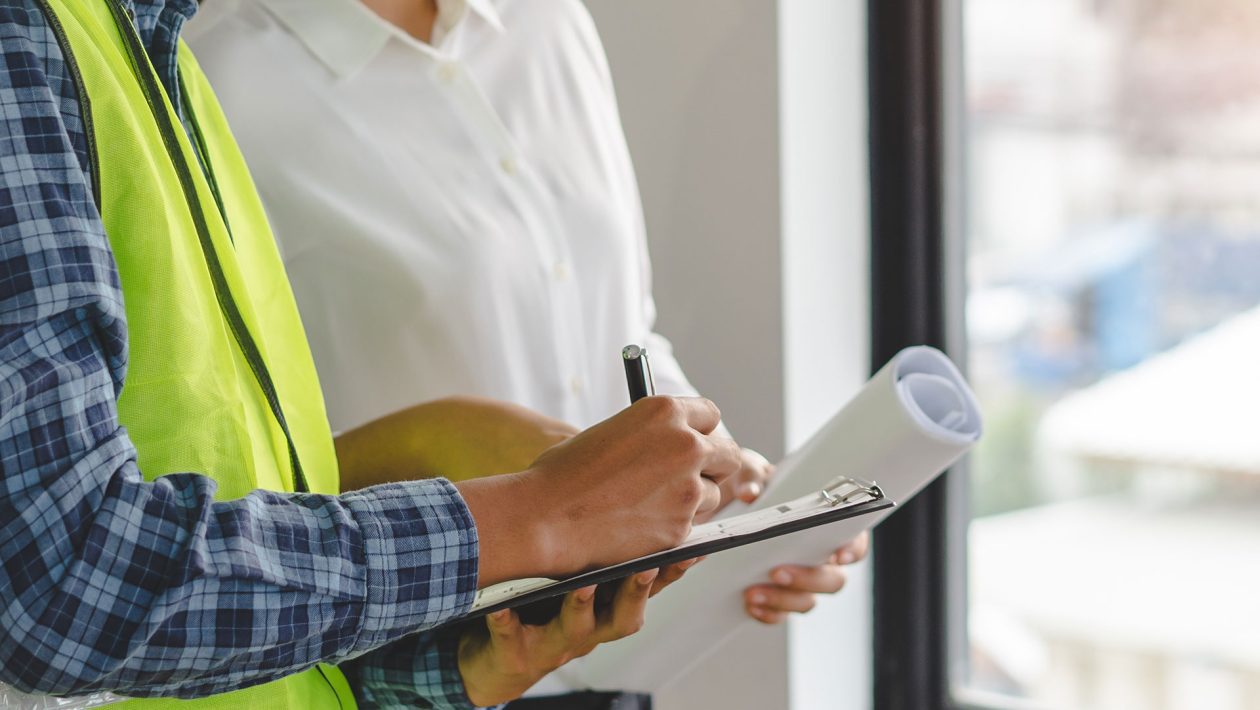 Inspector checking car dealership building        